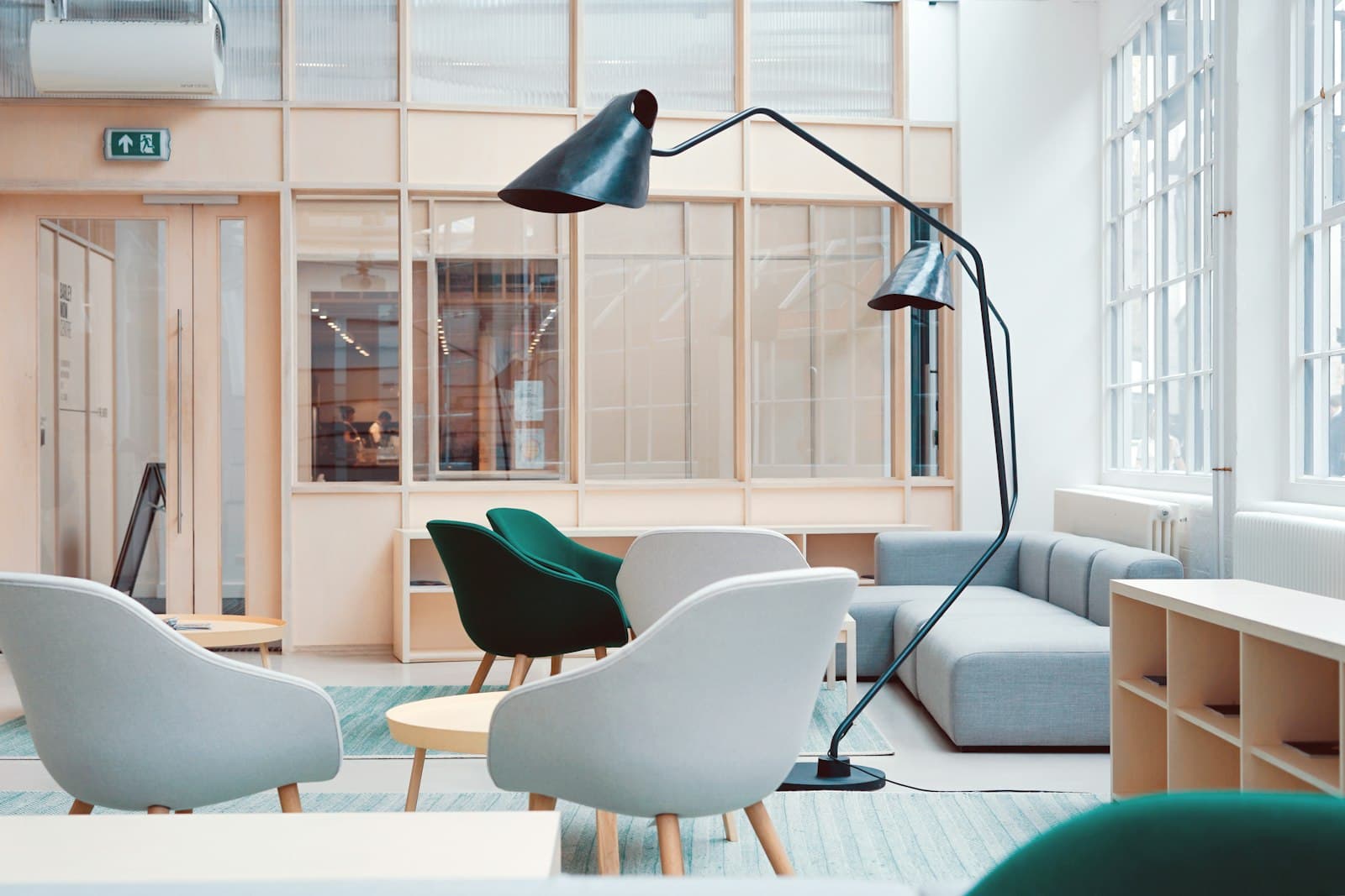 A quiet Amsterdam office lounge with daylight, timber joinery and considered furniture.